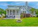 Spacious backyard with a screened porch, deck, firepit, and lush green lawn at 401 Felders Ln, Johns Island, SC 29455