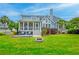 Backyard with a patio area, firepit, lush lawn, and mature landscaping at 401 Felders Ln, Johns Island, SC 29455