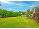 Expansive backyard featuring lush green grass, mature landscaping, and privacy fence at 401 Felders Ln, Johns Island, SC 29455