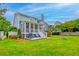Lush backyard featuring a firepit, screened porch, deck with grill, and mature trees at 401 Felders Ln, Johns Island, SC 29455