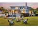 Charming backyard with fire pit, seating, deck, and lush lawn, ideal for outdoor living at 401 Felders Ln, Johns Island, SC 29455