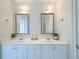 Bathroom vanity with double sinks, decorative mirrors, and modern lighting at 401 Felders Ln, Johns Island, SC 29455