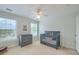 Bright Bedroom featuring a gray crib, dresser, and large windows for natural light at 401 Felders Ln, Johns Island, SC 29455
