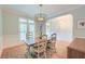 Cozy dining area with a rustic table, seating for six, and a modern chandelier at 401 Felders Ln, Johns Island, SC 29455