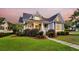 Charming two-story home featuring a cozy front porch and a well-manicured lawn with beautiful landscaping at 401 Felders Ln, Johns Island, SC 29455