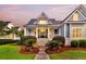 Inviting blue home with a manicured lawn and charming front porch at 401 Felders Ln, Johns Island, SC 29455