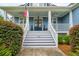 Inviting front porch with double doors, an American flag, and a well-kept entryway with stairs at 401 Felders Ln, Johns Island, SC 29455