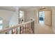 Upstairs hallway with wood and iron railing leading to carpeted bedrooms at 401 Felders Ln, Johns Island, SC 29455