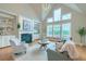 Bright living room featuring vaulted ceilings, built-in shelving, a fireplace, and large windows at 401 Felders Ln, Johns Island, SC 29455