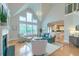 Open concept living room with fireplace, large windows, and views of the kitchen at 401 Felders Ln, Johns Island, SC 29455