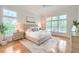 Bright main bedroom with hardwood floors, neutral decor, and large windows offering ample natural light at 401 Felders Ln, Johns Island, SC 29455