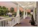 Relaxing front porch featuring wood floors, white railings, and neighborhood views at 401 Felders Ln, Johns Island, SC 29455