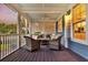 Comfortable screened porch with wicker furniture, ceiling fan, and calming blue ceiling at 401 Felders Ln, Johns Island, SC 29455