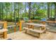 Wooden deck featuring outdoor seating, mature trees, a picnic table, and a serene backyard setting at 427 Grape Arbor Drive Dr, Summerville, SC 29486