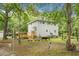 Backyard view of a two-story home featuring a wooden deck with mature trees, and a spacious yard at 427 Grape Arbor Drive Dr, Summerville, SC 29486