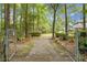 Gated entrance leading to a tree-lined driveway, providing privacy and a grand sense of arrival at 427 Grape Arbor Drive Dr, Summerville, SC 29486
