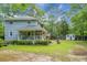 Two-story home featuring a covered porch and well-maintained landscaping, complemented by a spacious yard and trees at 427 Grape Arbor Drive Dr, Summerville, SC 29486