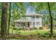 Charming two-story home with a covered front porch and well-maintained landscaping surrounded by mature trees at 427 Grape Arbor Drive Dr, Summerville, SC 29486