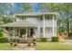 Two-story home featuring a covered porch, well-maintained landscaping, mature trees and a unique turret-style architectural design at 427 Grape Arbor Drive Dr, Summerville, SC 29486