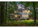 Charming two-story home with a covered front porch and well-maintained landscaping surrounded by mature trees at 427 Grape Arbor Drive Dr, Summerville, SC 29486