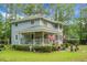 Two-story home featuring a covered porch and well-maintained landscaping, showcasing a charming and inviting curb appeal at 427 Grape Arbor Drive Dr, Summerville, SC 29486