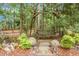 Rustic wooden swing under trees in a serene backyard setting, adorned with nature-inspired decor at 427 Grape Arbor Drive Dr, Summerville, SC 29486