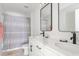 Functional bathroom featuring double sinks, sleek fixtures, and shower with curtain for added privacy at 428 Bluegill Ln, Johns Island, SC 29455