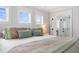 Close up on a bed with decorative pillows and colorful patterned pillows in an airy bedroom setting at 428 Bluegill Ln, Johns Island, SC 29455