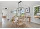 Bright dining room with a round wooden table, natural light, and wood flooring at 428 Bluegill Ln, Johns Island, SC 29455