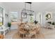 Sunlit dining area features a round table, natural light, and views of the neighborhood at 428 Bluegill Ln, Johns Island, SC 29455