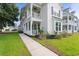 Inviting home exterior with white trim, lush lawn, and a sidewalk leading to the entrance at 428 Bluegill Ln, Johns Island, SC 29455