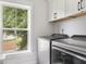 Laundry room with stainless steel washer and dryer and a window overlooking the backyard at 428 Bluegill Ln, Johns Island, SC 29455