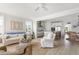 Bright living room with open floor plan featuring hardwood floors, a modern kitchen, and comfortable seating area at 428 Bluegill Ln, Johns Island, SC 29455