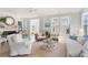 Bright living room with cozy furniture, natural light, and access to the kitchen and fireplace at 428 Bluegill Ln, Johns Island, SC 29455