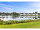 Picturesque view of a serene pond reflecting neighboring houses and clear blue sky on a sunny day at 428 Bluegill Ln, Johns Island, SC 29455