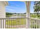 Scenic view from the porch overlooks a tranquil pond and neighboring homes under a blue sky at 428 Bluegill Ln, Johns Island, SC 29455