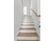Bright staircase with wooden steps and handrail with white risers and walls at 428 Bluegill Ln, Johns Island, SC 29455