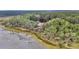 Aerial view of a red house nestled in a lush, green forest near a lake at 4352 Park Island Rd, Hollywood, SC 29449