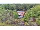 Aerial view of a two-story home with solar panels, a screened porch, and surrounded by lush trees at 4352 Park Island Rd, Hollywood, SC 29449