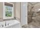 Modern bathroom with a soaking tub, a glass-enclosed shower, and a window that allows natural light at 4352 Park Island Rd, Hollywood, SC 29449