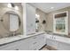 Elegant bathroom featuring double sinks with granite countertops, white cabinets, and a soaking tub at 4352 Park Island Rd, Hollywood, SC 29449