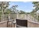 Inviting deck with outdoor seating, surrounded by lush trees and blue skies, offering a serene view at 4352 Park Island Rd, Hollywood, SC 29449