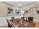 Formal dining room with a large table, elegant chandelier, and staircase in the background at 4352 Park Island Rd, Hollywood, SC 29449