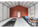 Interior of outdoor building with garage door, concrete floors and ride-on lawnmower at 4352 Park Island Rd, Hollywood, SC 29449