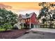 Beautiful two-story home with a metal roof, inviting front porch, and a three-car garage at 4352 Park Island Rd, Hollywood, SC 29449