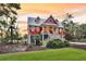 Charming two-story home with a inviting porch and stairway, nestled in a lush, landscaped yard at 4352 Park Island Rd, Hollywood, SC 29449