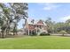 Charming two-story home with a well-maintained lawn and beautiful trees at 4352 Park Island Rd, Hollywood, SC 29449