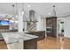 Open kitchen with hardwood floors, stainless hood, marble counters, and an island that offers plenty of space at 4352 Park Island Rd, Hollywood, SC 29449