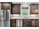 Well-equipped kitchen boasts stainless steel appliances, dark wood cabinets, and a bright window with a view at 4352 Park Island Rd, Hollywood, SC 29449