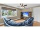 Living room featuring a large window with view, hardwood floors, and a blue sofa at 4352 Park Island Rd, Hollywood, SC 29449
